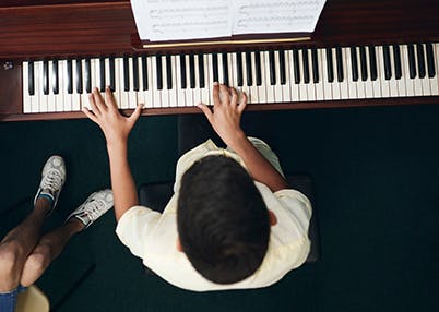 Little boy practicing piano